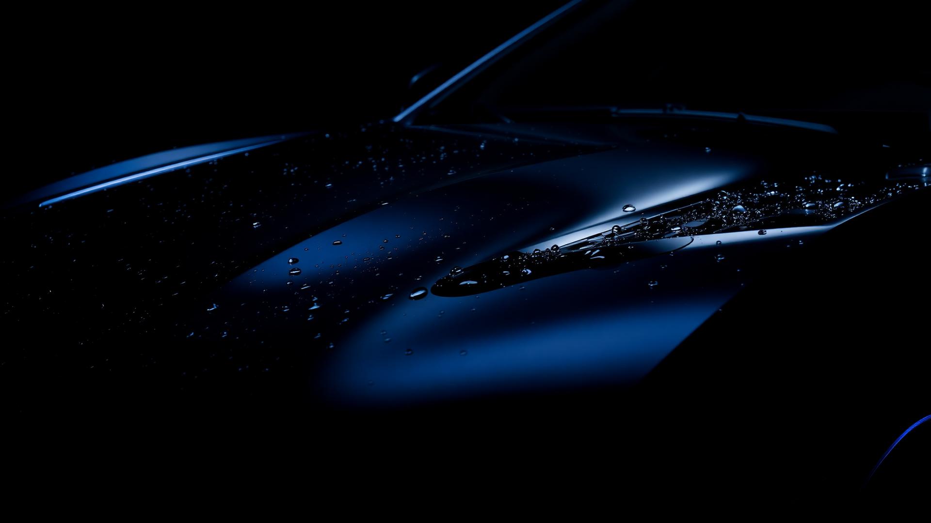 Ceramic-coated black car with water beading on the paint
